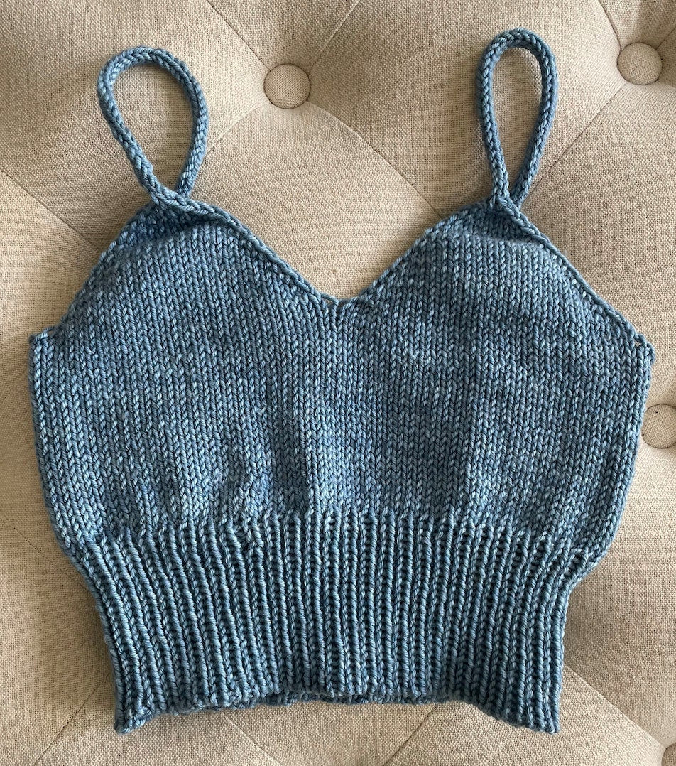 Blue knitted camisole laid flat