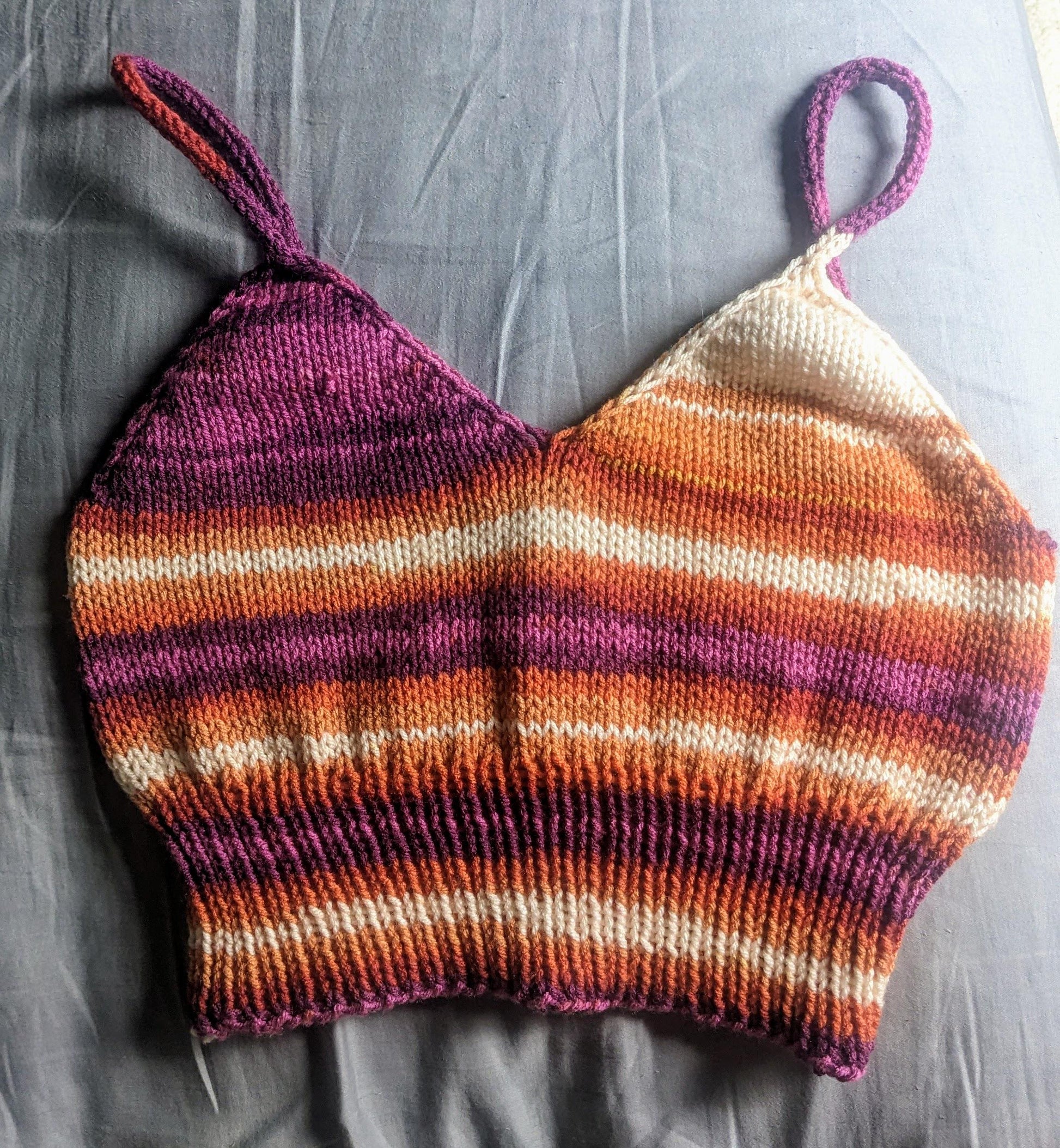 Purple and orange striped knitted camisole laid flat