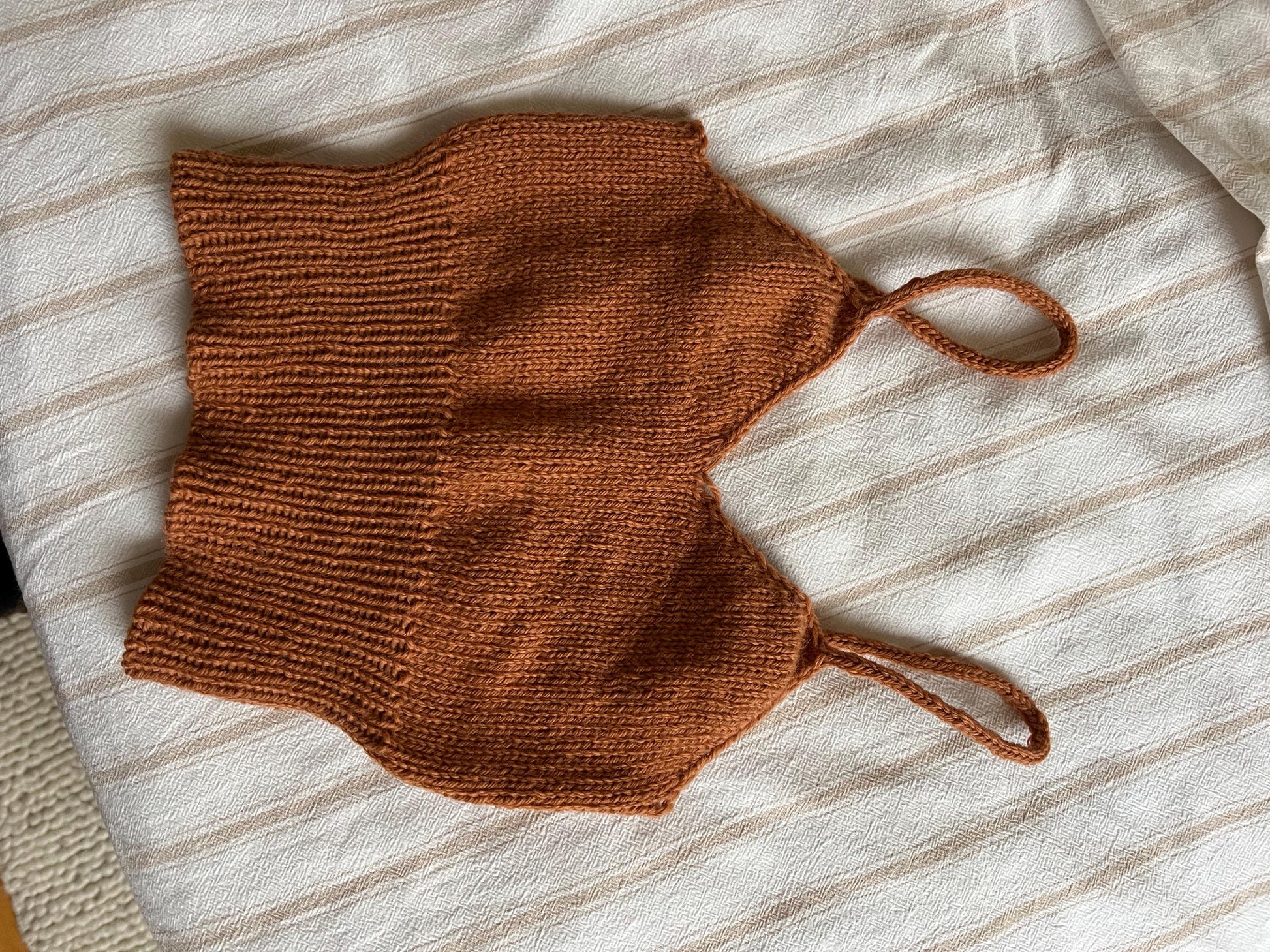 Rust knitted camisole laid flat