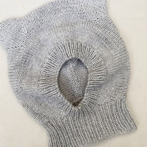Grey bear-ear hood laid flat to show its shape