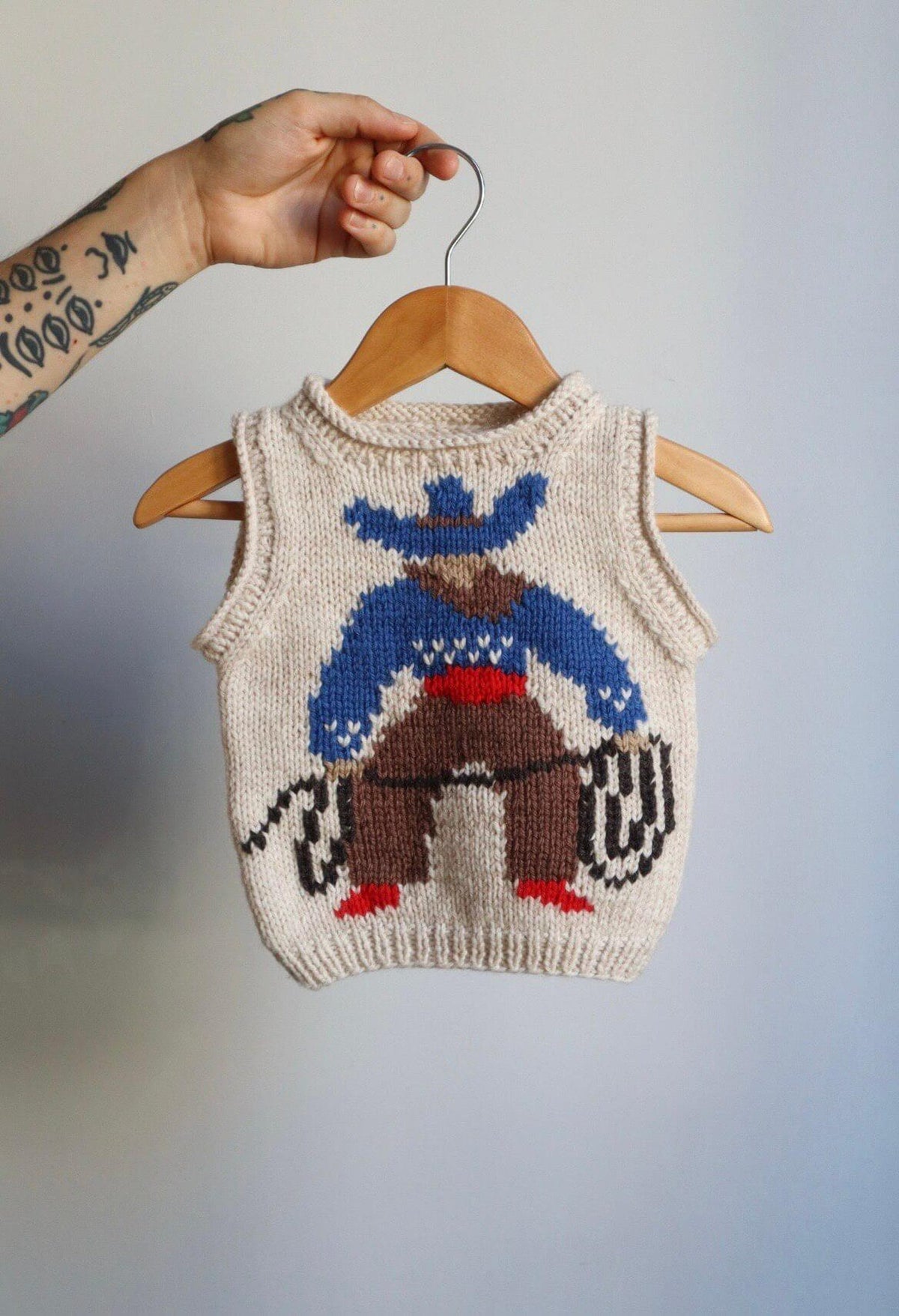 Little Folk Friend Vest with cowboy motif, front view